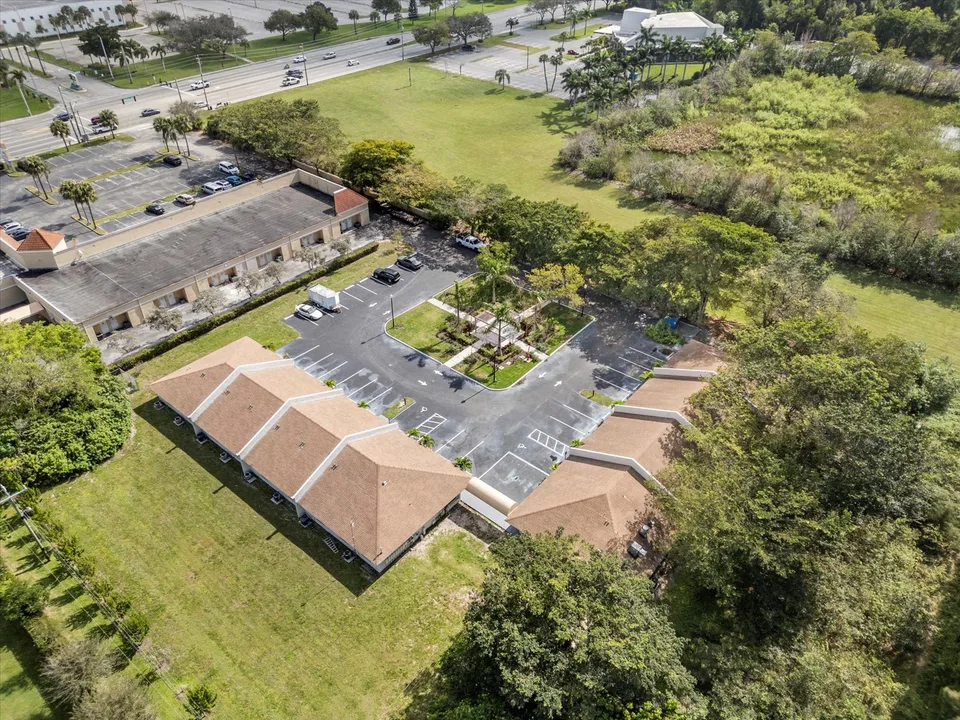 Aerial view of buildings, parking areas and surrounding green space
